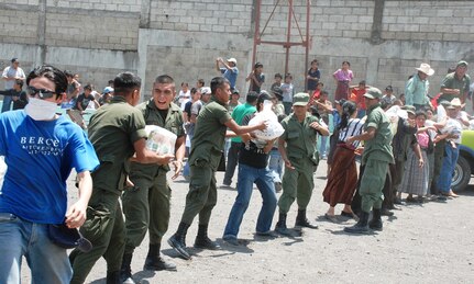 Guatemalan military and citizens of Santiago Atitlan, Guatemala offload disaster relief supplies from a Joint Task Force-Bravo UH-60 Blackhawk June 6. Joint Task Force-Bravo’s helicopters have transported approximately 152,000 pounds of relief supplies since June 2 to 14 Guatemalan communities in need. (U.S. Air Force photo by 1st Lt. Jen Richard)