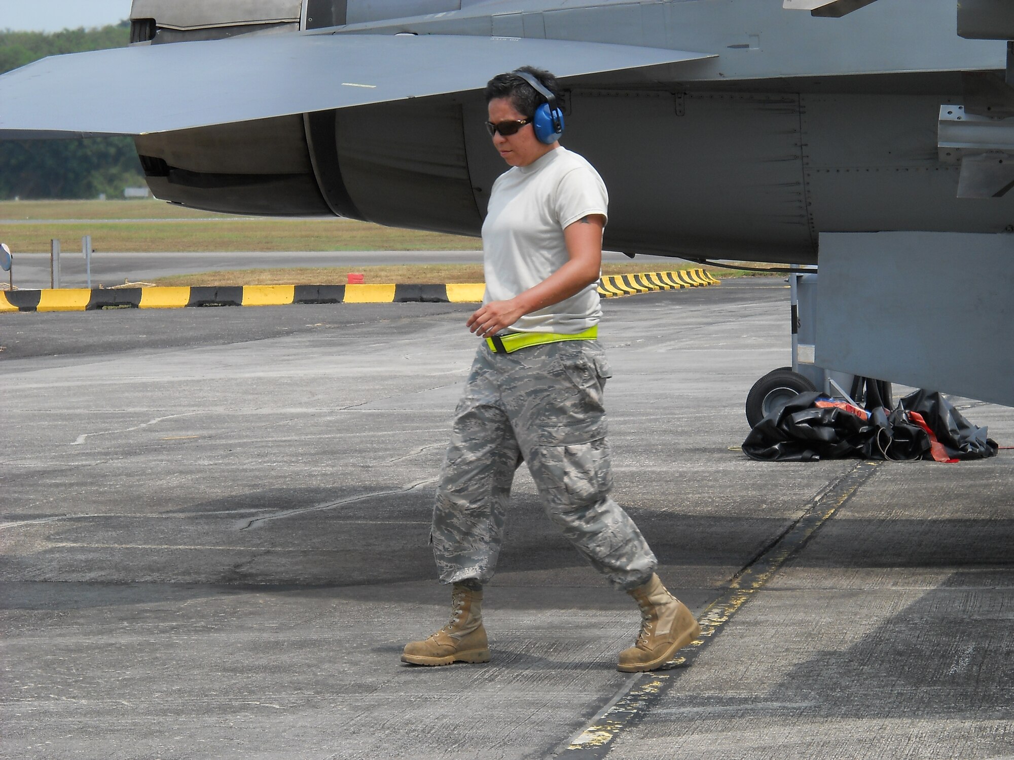 Staff Sgt. Alicia Valenzuela, 51st Maintenance Squadron, walks away from an F-16 prior to takeoff during a previous assignment to Paya Lebar Air Base, Singapore. Sergeant Valenzuela was recently selected to join the U.S. Thunderbirds team.