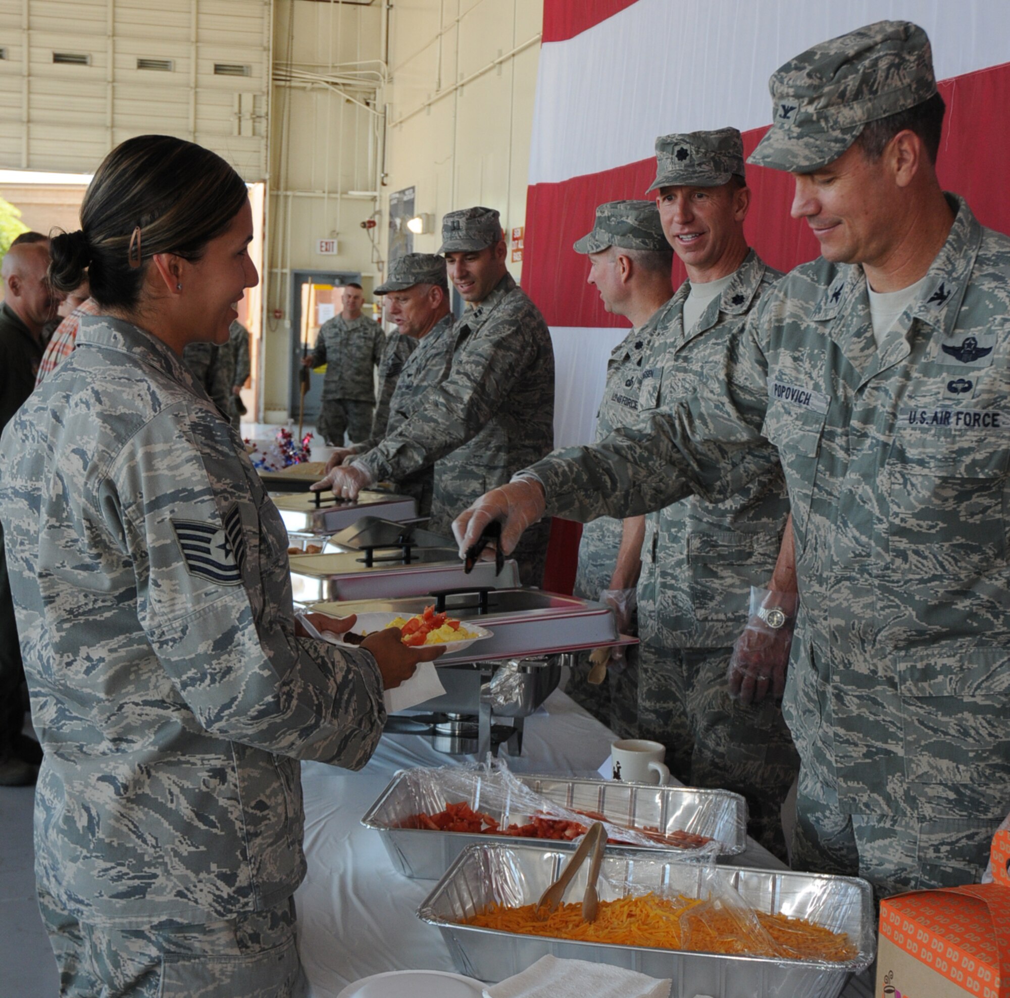 Col. Michael Popovich, 944th Fighter Wing commander, adds tomatoes and cheese to Tech. Sgt. Rebecca Collins, 944th Mission Support Flight member, plate during the wing's breakfast on June 6.  The breakfast was held to thank 944th Fighter Wing members for their excellent job during the recent UCI, HSI, and LCAP inspections. (U.S. Air Force Photo/Staff Sgt. Denise Willhite)