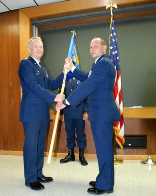 PATRICK AIR FORCE BASE, Fla. -  Col. Christopher Hannon, 920th Rescue Wing Operations Group Commander, passes the guidon, and command of the 308th Rescue Squadron to Lt. Col. Kurt Matthews during a change of command ceremony here. The 308th RQS is home to combat rescue officers (CROs), pararescuemen (PJs) and survive, evade, resist and escape specialists (SERE) - all of which fall under the Guardian Angel Weapon System (GAWS). (U.S. Air Force photo/Staff Sgt. Leslie Kraushaar)