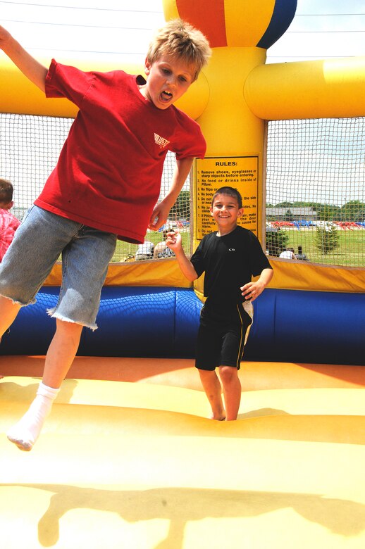 Left: Jacob Singer, son of Tech. Sergeant Rick Singer and Michael Baker, son of Tech. Sergeant Shane Baker, play on the bouncing castle at the annual 185th Family Fun Day in, Sgt. Bluff, Iowa, on June 5th, 2010.

