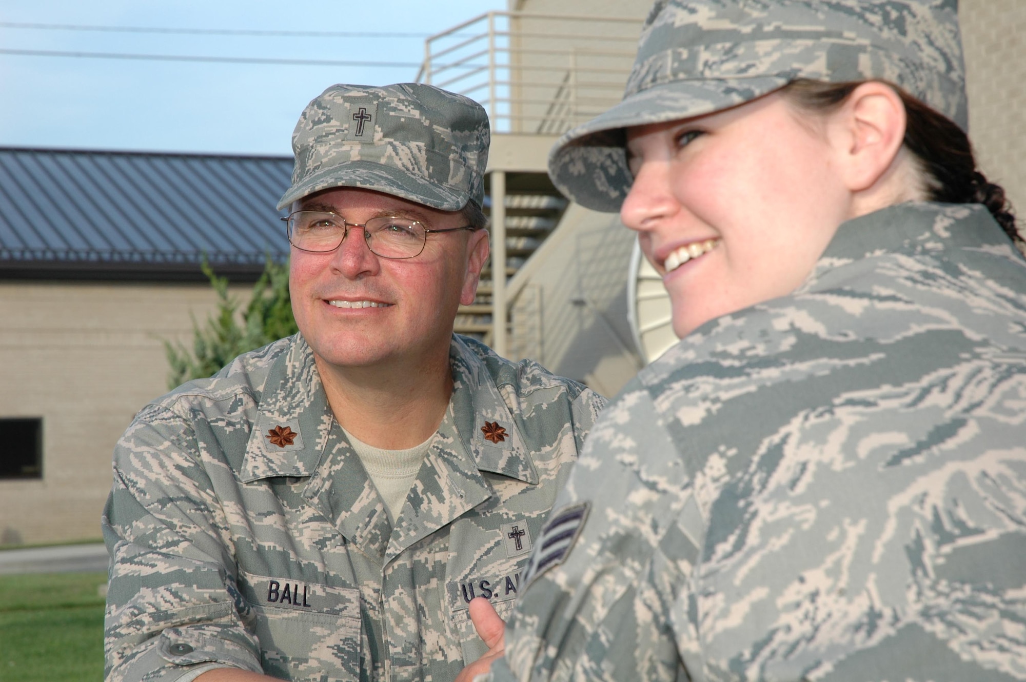 Chaplain (Maj.) Barry Ball, 512th Airlift Wing Chaplain, talks with Senior Airman Julia Haas, 512th AW chaplain assistant, outside the wing staff agency building here June 6. Chaplain Ball is available to meet with servicemembers and their families to discuss personal issues. All conversations with the chaplain are protected under privileged communication -- meaning that all matters discussed remain private. (U.S. Air Force photo/Staff Sgt. James Bolinger)