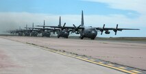 Six Air Force Reserve C-130 Hercules roll down the taxiway June 5 at Peterson Air Force Base, Colo. After performing practice air drops over eastern Colorado, each of the aircraft joined together for a multi-ship formation flight over the base. Later, the six C-130s simulated tactical air drops at the Red Devil tactical airstrip at nearby Ft. Carson. Typically, C-130 wings in the AF Reserve only fly in multi-ship formations once or twice a year to simulate combat conditions while flying in close formation. Five of the C-130 aircrews are assigned to the 302nd Airlift Wing at Peterson AFB, which included both AF Reserve and Active Duty Airmen. The final aircraft and aircrew were assigned to the 94th Airlift Wing, based at Dobbins Air Reserve Base outside of Atlanta. (U.S. Air Force photo/Tech. Sgt. Daniel Butterfield)