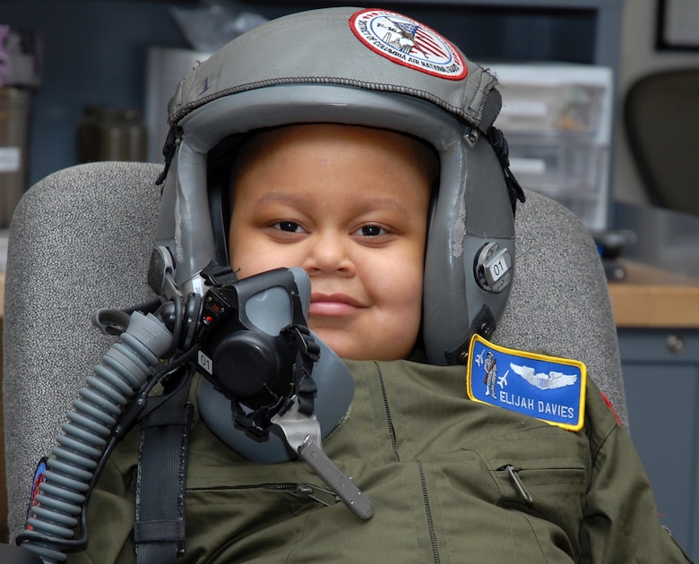 The Pilot for a Day, Elijah Woods, who is recovering from two major surgeries to remove a brain tumor, receives a demonstration of flight gear prior to getting into an F-16 flight simulator with the 121 FS at Andrews Air Force Base, 22 April 2010.