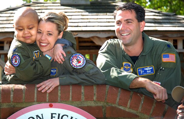 Maj Suzanne Shulz and Lt Col. Rob Balzano, 201 AS pilots and co-coordinators of Pilot For a Day program, welcome Elijah Woods to Andrews Air Force base, 22 April 2010.