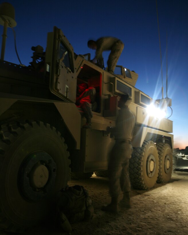 Members of the Personal Security Detail, Combat Logistics Battalion 6 make last minute weapons and communications checks prior to heading to Buji Pass with the battalion commanding officer and sergeant major June 6. Prior to deploying in support of Operation Enduring Freedom, the Marines learned evasive driving techniques, controlled collision procedures and various other defensive tactics to include fighting withdrawals and complex ambush negotiations.