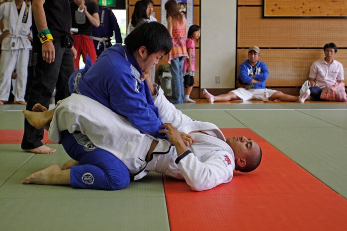 Ivan Ortega, white-belt competitor, grabs hold of his opponent’s gi as he defends himself against a mount during the 4th annual Chugoku-Shikoku Jujitsu Championship at the Hiroshima Minami Ward Sports Center, June 6. The gi is an important aspect in Jujitsu, allowing competitors to execute moves and use it in ways such as wrapping the gi around the arm or using it to pull them down.