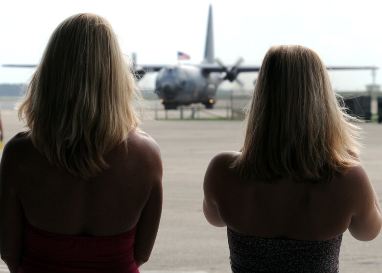 A wife and daughter watch a 919th Special Operations Wing Combat Talon return home from an Operation Iraqi Freedom deployment to Eglin Air Force Base, Fla., June 6. More than 70 reservists and two Combat Talons from Duke Field returned home June 5 and 6. Friends, family, co-workers and community leaders came out to greet them and welcome the Airmen home. (U.S. Air Force photo/Tech. Sgt. Samuel King Jr.)