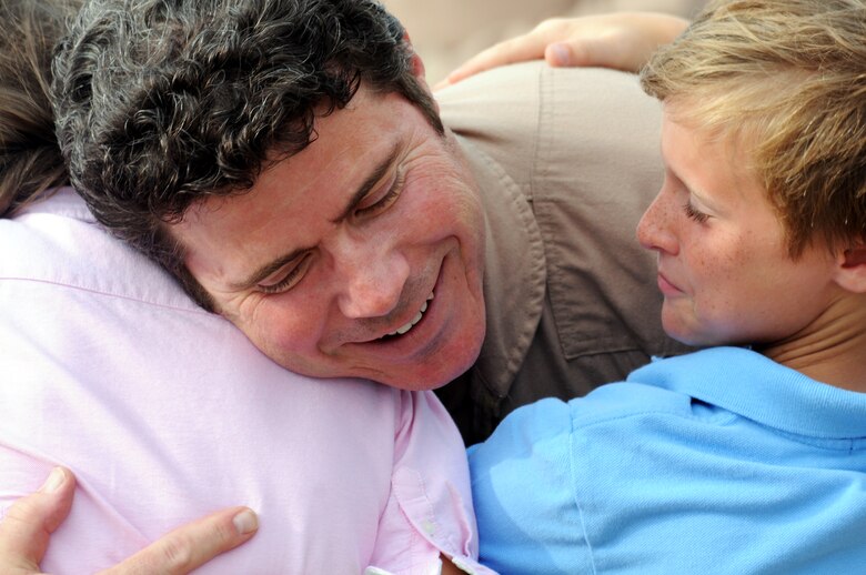 Lt. Col. Frank Daldine receives a much-needed, welcome-home hug June 6 at Eglin Air Force Base, Fla., upon returning from an Operation Iraqi Freedom deployment. More than 70 Airmen from Duke Field returned home from their deployment June 5 and 6. Friends, family, co-workers and community leaders came out to greet them and welcome the Airmen home. (U.S. Air Force photo/Tech. Sgt. Samuel King Jr.) 