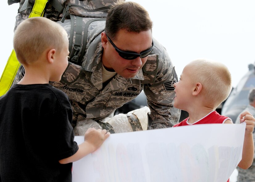 Tech Sgt. Aaron McCutcheon, 919th Maintenance Group, checks out the “welcome home” sign his two sons made for him upon returning from an Operation Iraqi Freedom June 6 at Eglin Air Force Base, Fla. More than 70 Airmen from Duke Field returned home from their deployment June 5 and 6. Friends, family, co-workers and community leaders came out to greet them and welcome the Airmen home. (U.S. Air Force photo/Tech. Sgt. Samuel King Jr.) 