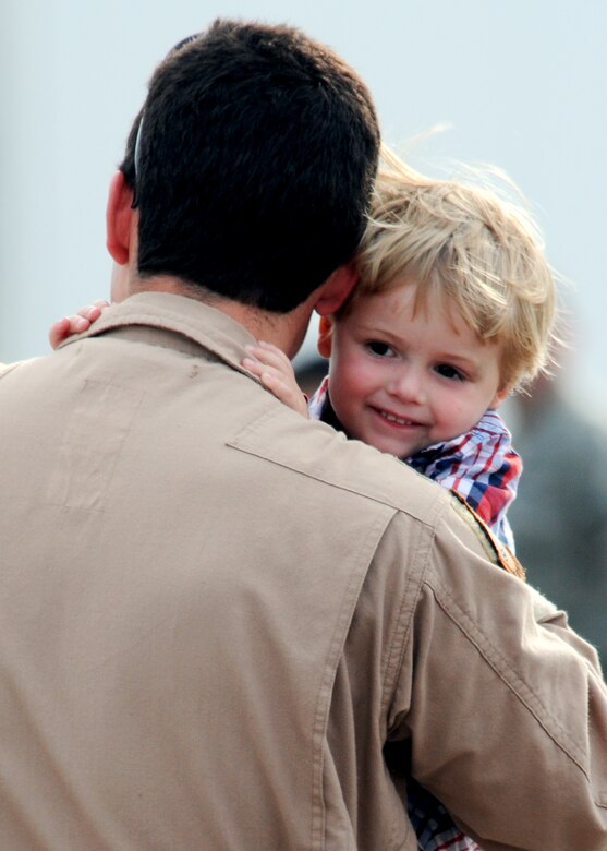 A father from the 919th Special Operations Wing, carries around his son upon returning from an Operation Iraqi Freedom deployment June 6 at Eglin Air Force Base, Fla. More than 70 Airmen from Duke Field returned home from their deployment June 5 and 6. Friends, family, co-workers and community leaders came out to greet them and welcome the Airmen home. (U.S. Air Force photo/Tech. Sgt. Samuel King Jr.) 