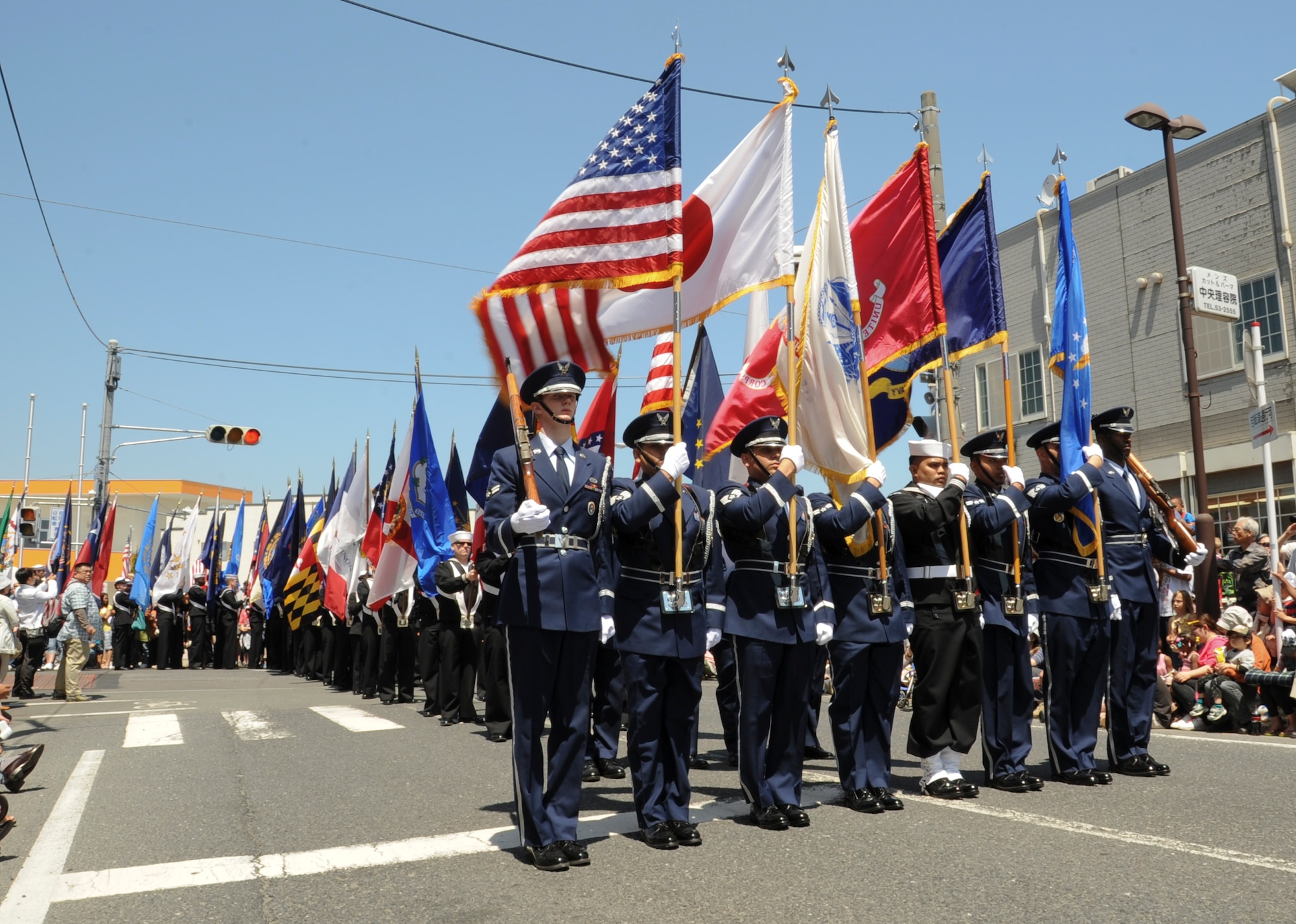 MISAWA AIR BASE, Japan -- Misawa Air Base honor gaurd leeads the 22nd annual American day parade June 6, carrying the U.S, Japan and, indiviual services flags, following behind sailors from Misawa Air Base carry 50 state flags. (U.S. Air Force photo/Technical Sgt. Russell McBride)
