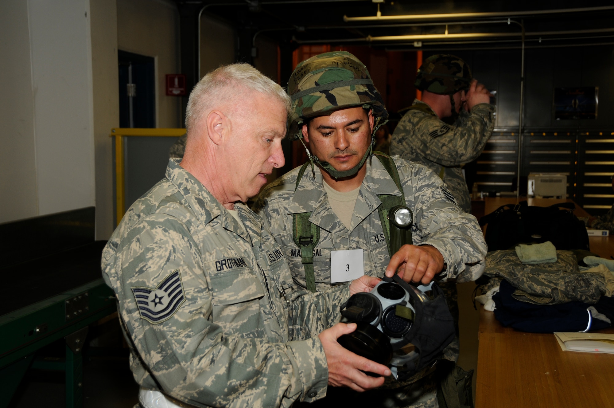 U.S. Air Force Tecnical Sgt. Michael Grothman with the 144th Fighter Wing Logistics Readiness Squadron inpects Senior Airman Ruben White's gas mask for an Operational Rediness Inspection (ORI) at Fresno Air National Guard Base, California, June 05, 2010. The ORI is used to see if units can deploy at a monents notice. (U.S. Air Force Photo by Technical Sgt. Robin Meredith/Released)