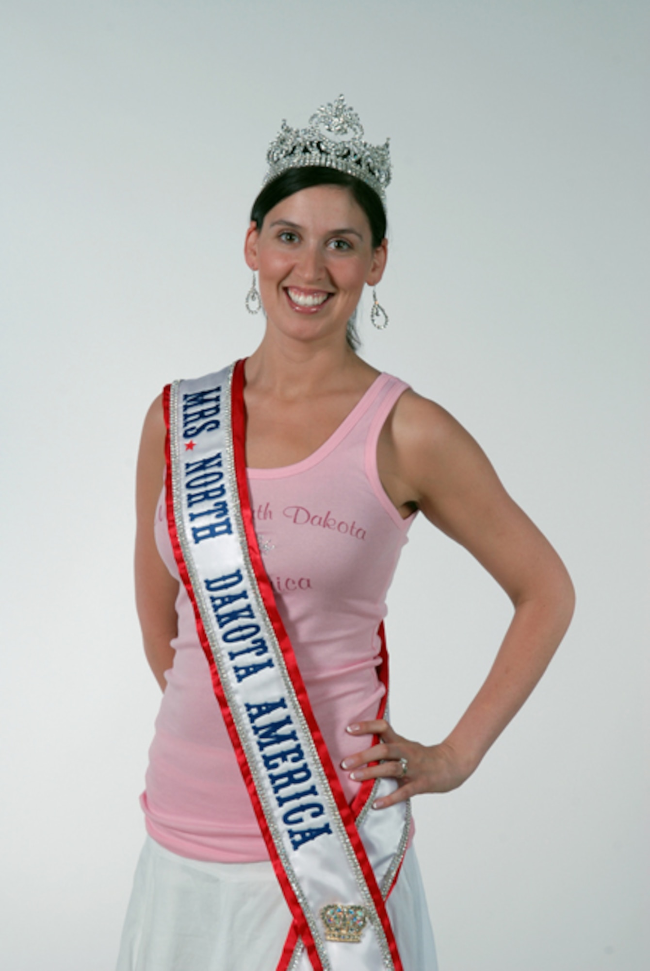 Newly crowned Mrs. North Dakota America, Tech. Sgt. Tera Miller, of the 119th Operations Support Squadron, takes time to pose for a portrait as she visits her work area June 7, at the North Dakota Air National Guard, Fargo, N.D.  Miller was selected 2010 Mrs. North Dakota America at the Grand Masonic Lodge, June 6, in Fargo.  One of Millers competitors for the crown was fellow Guard member SGT. Jill Johnson, with the North Dakota Army National Guard.  Miller will advance to the National Mrs. America pageant in Tuscan, Ariz., in September. Miller, along with her twin sister Tech. Sgt. Lisa Narum joined the North Dakota Air National Guard in 2001.  (DoD photo by Senior Master Sgt. David H. Lipp) 