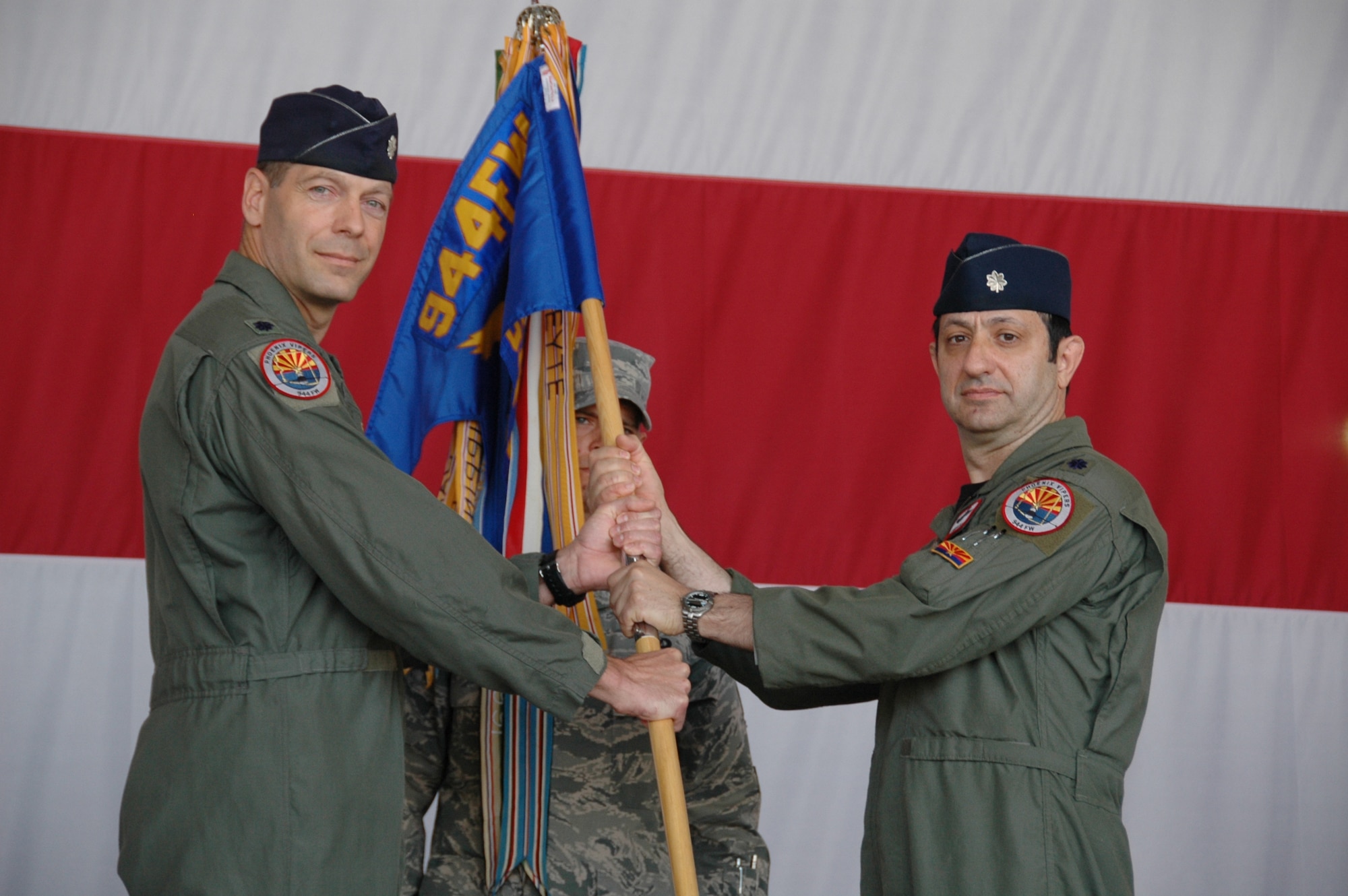 Lt. Col. David Garfield, 944th Operations Group commander, passes the guidon
to Lt. Col. Mike Torrealday June 4 as he assumes command of the 69th Fighter
Squadron. Lt. Col. Steve Speckhard relinquished command during the
change-of-command ceremony. (U.S. Air Force photo/Tech. Sgt. Susan Stout)
