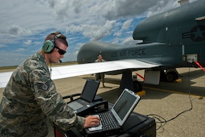 Staff Sgt. Ryan Conversi prepares the RQ-4 Global Hawk for launch using the vehicle test controller while reviewing technical orders May 26, 2010, at Beale Air Force Base, Calif. Sergeant Conversi is a crew chief assigned to the 12th Reconnaissance Squadron. (U.S. Air Force photo/Staff Sgt. Bennie J. Davis III)