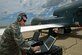 Staff Sgt. Ryan Conversi prepares the RQ-4 Global Hawk for launch using the vehicle test controller while reviewing technical orders May 26, 2010, at Beale Air Force Base, Calif. Sergeant Conversi is a crew chief assigned to the 12th Reconnaissance Squadron. (U.S. Air Force photo/Staff Sgt. Bennie J. Davis III)