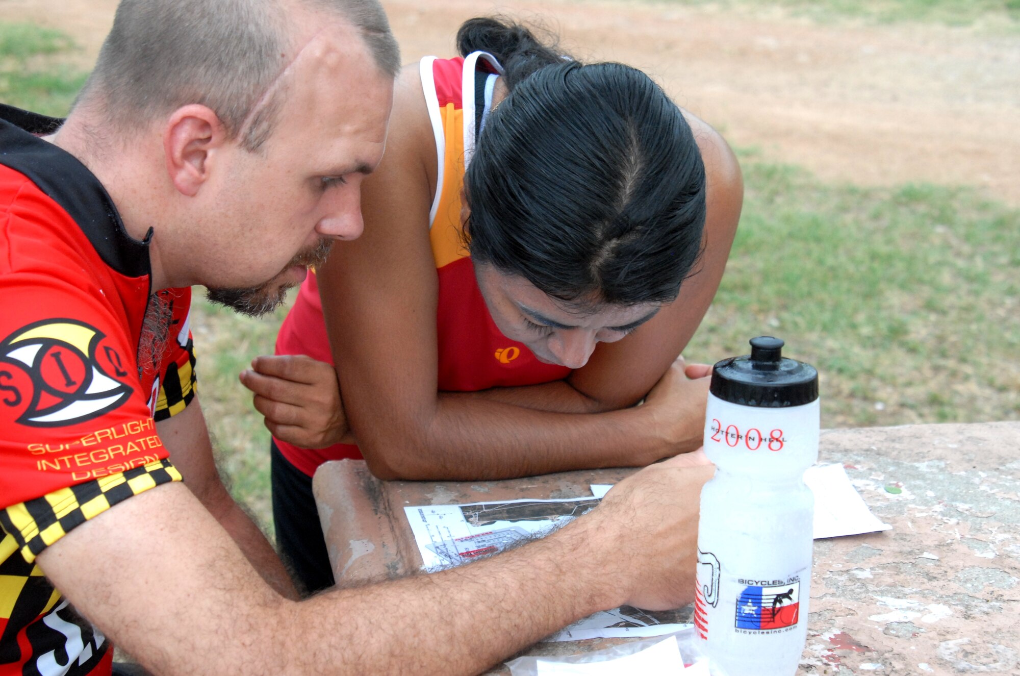 Team Dunn Together members, Mari Dunn, 17th Comptroller Squadron, and her husband, Kelly, map out their strategy during the Adventure Race June 6. Dunn Together completed the race in just over four hours taking third place in the Co-ed Team Category. (U.S. Air Force photo/Connie Hempel)