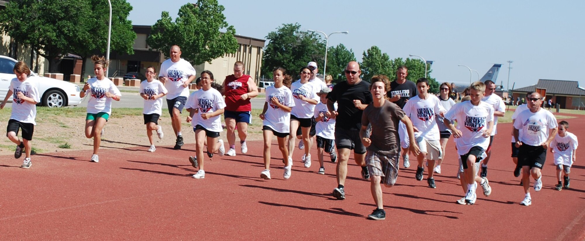Nine-to 18-year-old children and their families begin a 2-mile run during the American Armed Forces Kids Run at the 1-mile track on Sheppard Air Force Base, Texas, June 5, 2010. More than 100 participants dashed around the track, running distances ranging from .5 to 2 miles. (U.S. Air Force photo/ Airman 1st Class Valerie Hosea)