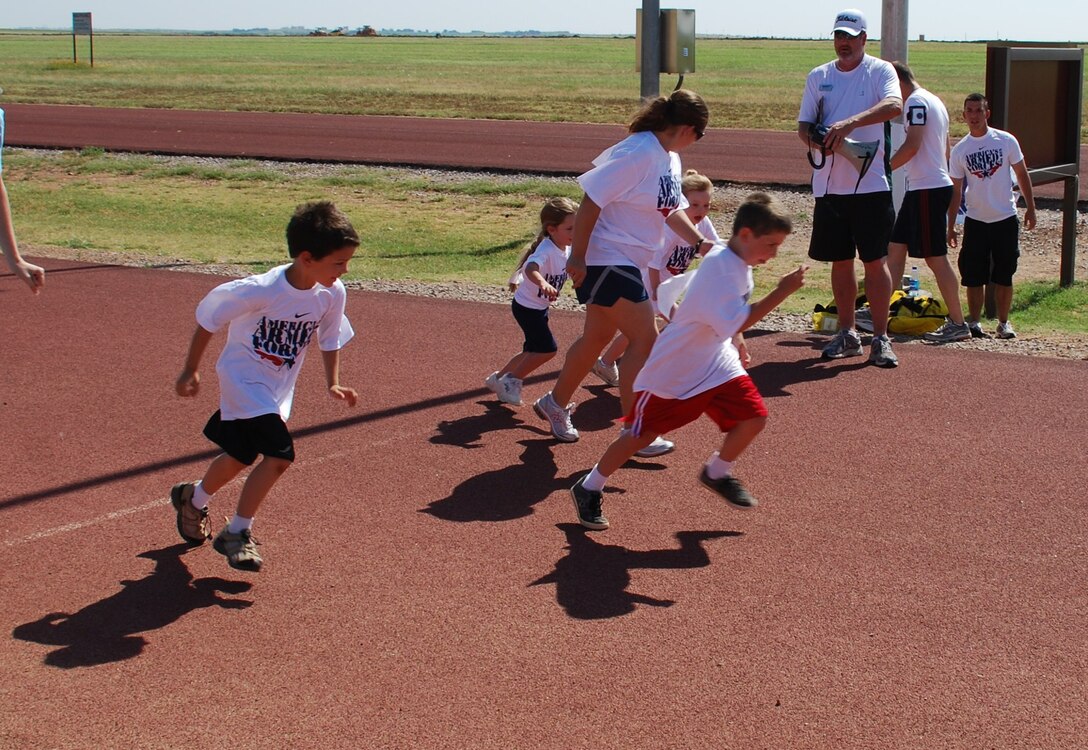Five-and 6-year-old children and their families begin a .5-mile run during the American Armed Forces Kids Run at the 1-mile track on Sheppard Air Force Base, Texas, June 5, 2010. More than 100 participants dashed around the track, running distances ranging from .5 to 2 miles. (U.S. Air Force photo/ Airman 1st Class Valerie Hosea)