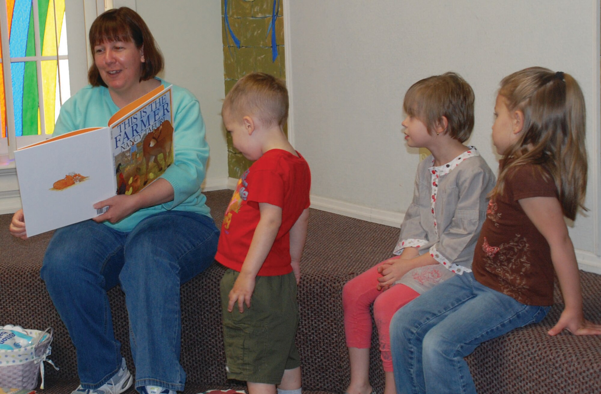 Tekla Slider, library director, reads to children during story hour in the base library May 21. Story hour takes place every Friday at 11 a.m. (U.S. Air Force photo/Airman 1st Class Jennifer Viveiros)