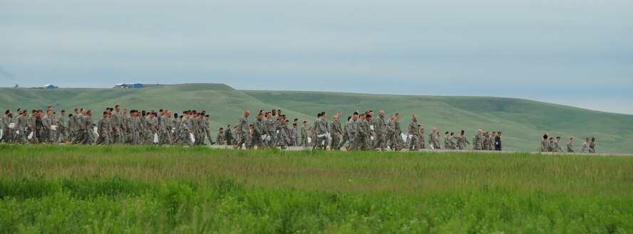 ELLSWORTH AIR FORCE BASE, S.D. -- Airmen walk the flightline during a foreign object debris walk, June 7.  The FOD walk helps ensure the flightline is free of potentially hazardous debris and is safe for aircraft to take off and land. (U.S. Air Force photo/Airman 1st Class Anthony Sanchelli)

