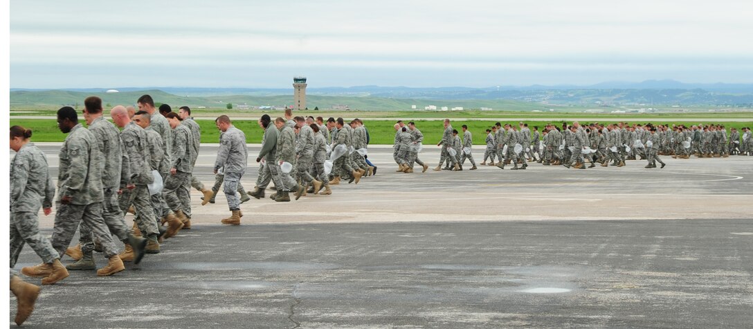 ELLSWORTH AIR FORCE BASE, S.D. -- Airmen from every career field participate in a foreign object debris walk, June 7.  The FOD walk is a simple way to bring all of Ellsworth's Airmen together and help keep the flightline free of potentially hazardous debris which could cause millions of dollars worth of damage to a jet. (U.S. Air Force photo/Airman 1st Class Anthony Sanchelli)

