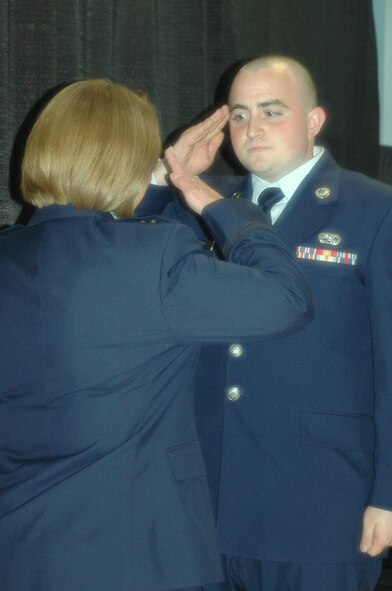Senior Airman Phillip Carter renders a salute to his mother Brig. Gen. Carter during her promotion ceremony May 28. Carter is the Chief of Staff of the New Hampshire Air National Guard and the first female general in the New Hampshire National Guard.  Photo: 1st Lt. Sherri Pierce 157th ARW-PA