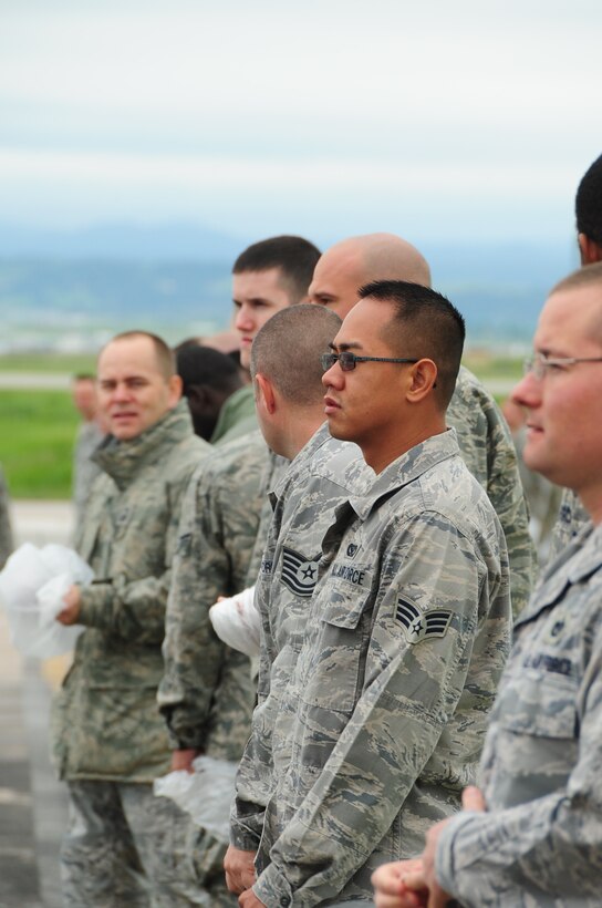 ELLSWORTH AIR FORCE BASE, S.D. -- Airmen line up on the flightline before conducting a foreign object debris walk, June 7.  The FOD walk brought the base together to clear any potentially hazardous debris from the flightline which could cause millions of dollars worth of damage to a jet. (U.S. Air Force photo/Airman 1st Class Anthony Sanchelli)

