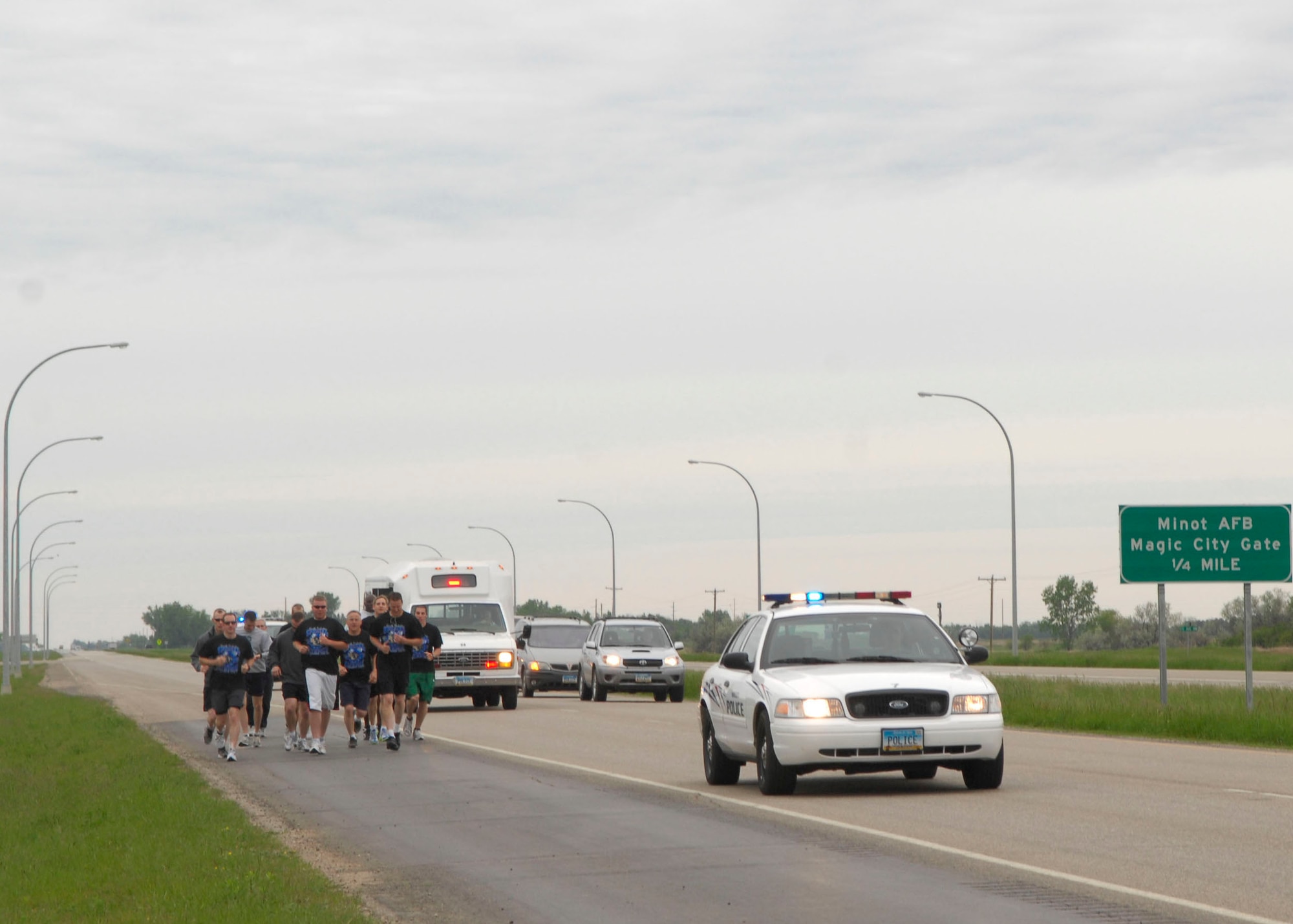 MINOT, N.D. -- Members of Team Minot participate in the Minot Special Olympic Torch Run here June 3. In spite of foul weather, participants ran the full 16 miles, which started from the Magic City Gate of Minot AFB and ended in downtown Minot. (U.S. Air Force photo by Senior Airman Ashley N. Avecilla) 