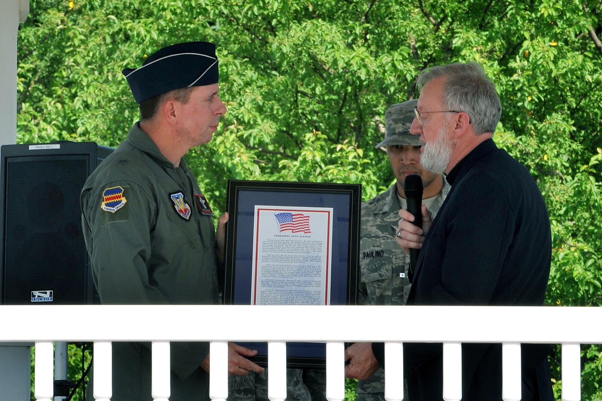 OFFUTT AIR FORCE BASE, Neb. - Brig. Gen. John N.T. Shanahan, 55th Wing commander, receives a poem entitled "Permanent Duty Station" at the parade grounds here June 3 from the poems' writer, parrish Pastor Paul Goddard. The poem, written to honor all servicemembers, was officially presented to General Shanahan as a way to thank the members of Team Offutt for all they do. U.S. Air Force Photo by Charles Haymond