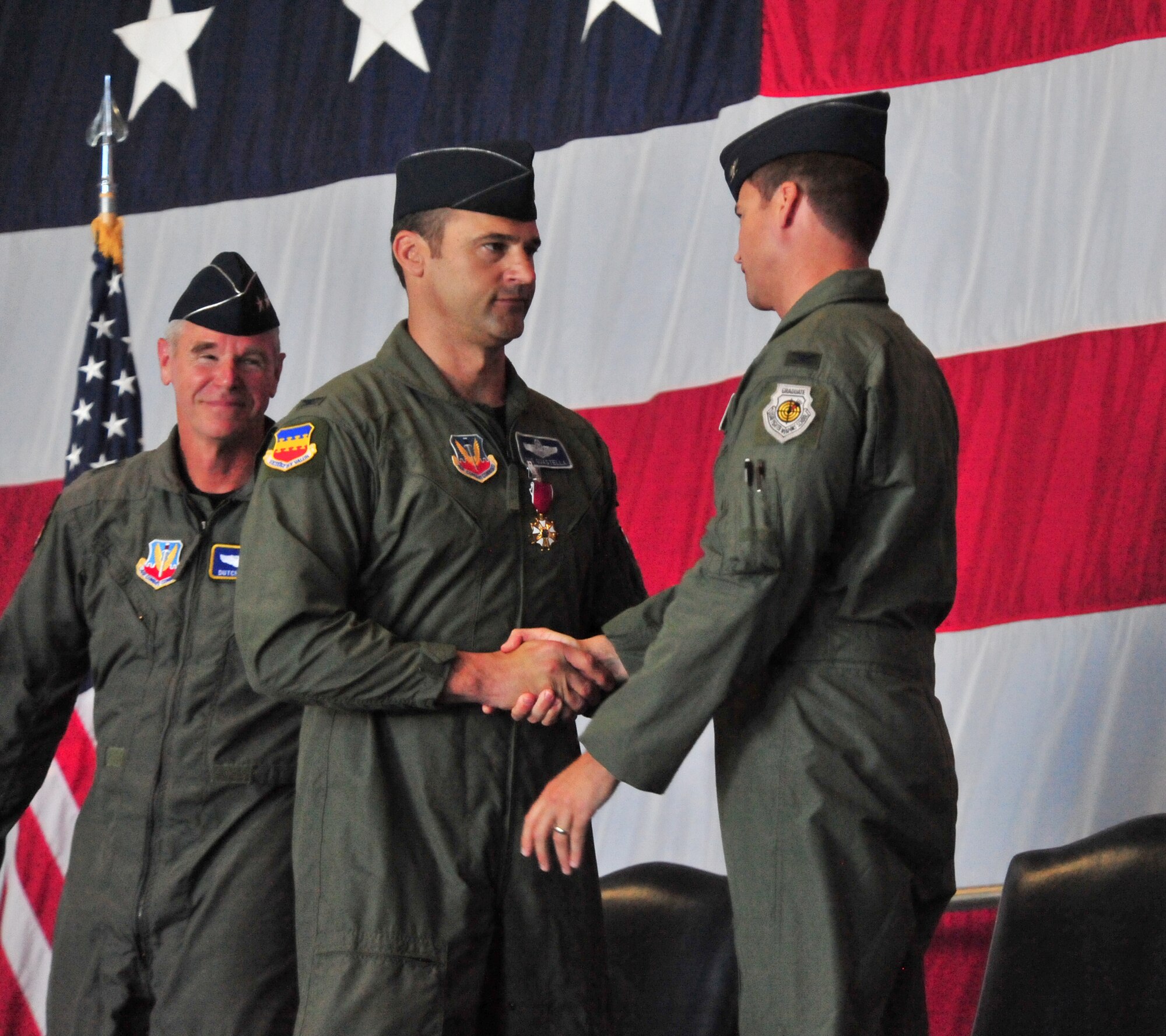 100605-F-8430J-122
SHAW AIR FORCE BASE, S.C. -- Colonel Joseph Guastella shakes Colonel Charles Moore (right) hand during the change of command on June 4, 2010. Airmen of the 20th Fighter Wing came together in Hangar 1200 here to welcome their new commander. Colonel Charles Moore took over command of the 20th FW from Col. Joseph Guastella at a ceremony officiated by Maj. Gen. William Holland, 9th Air Force commander. (U.S. Air Force photo/Airman 1st Class Amber E. Jacobs)

