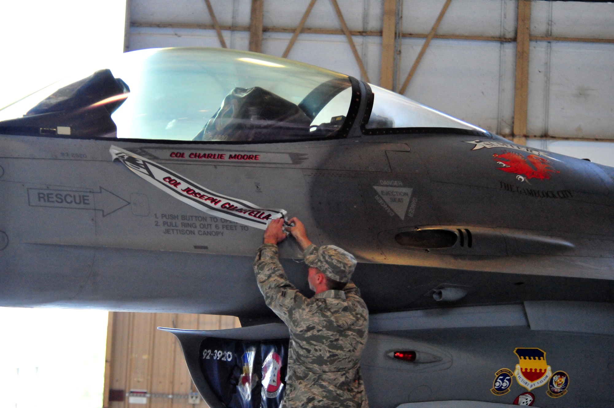 100605-F-8430J-184
SHAW AIR FORCE BASE, S.C. -- Colonel Charles Moore's name is unveiled on the F-16 fighter jet during the change of command on June 4, 2010. Airmen of the 20th FW came together in Hangar 1200 here to welcome their new commander. Colonel Charles Moore took over command of the 20th FW from Col. Joseph Guastella at a ceremony officiated by Maj. Gen. William Holland, 9th Air Force commander. (U.S. Air Force photo/Airman 1st Class Amber E. Jacobs)

