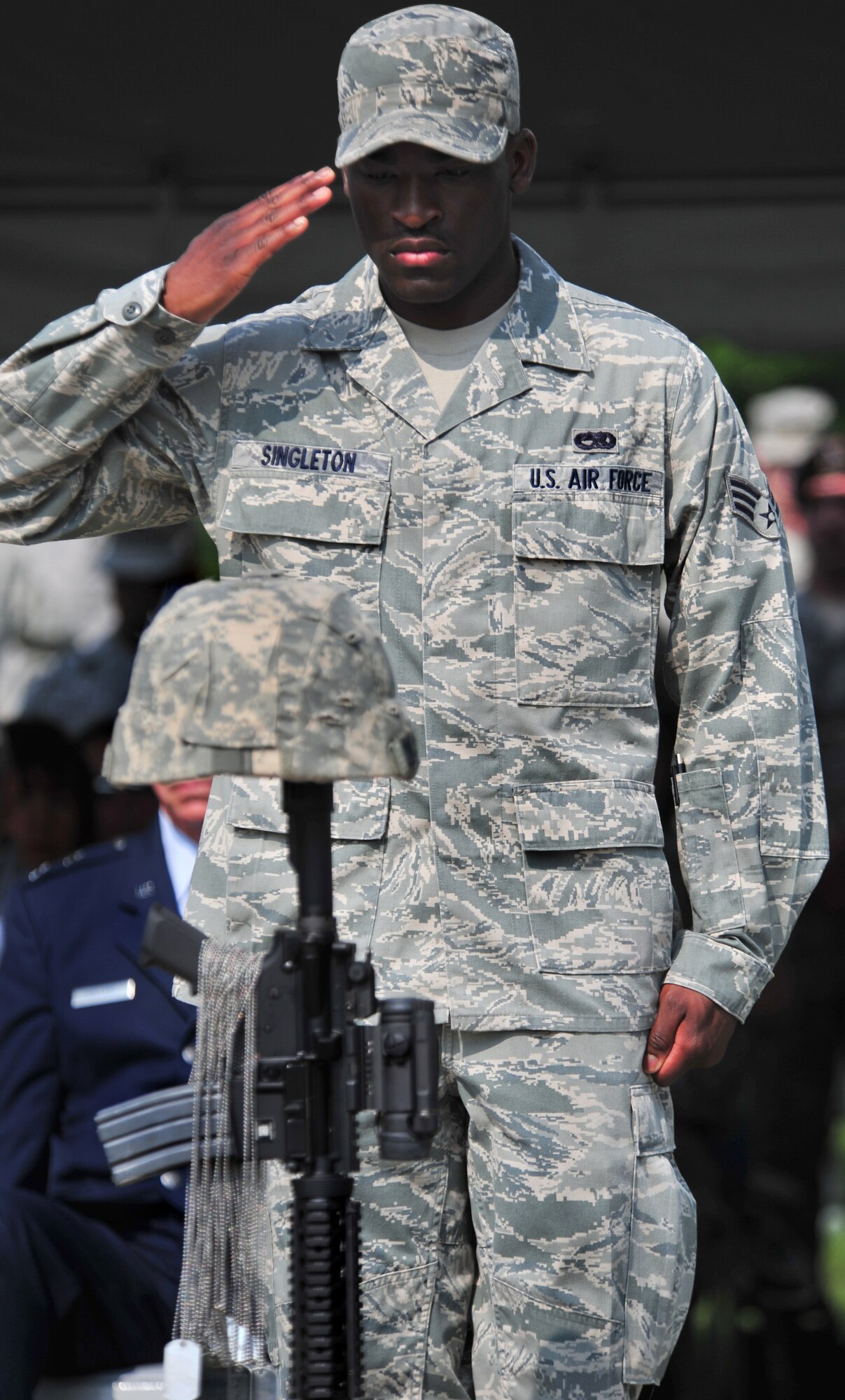 100602-F-8430J-482
SHAW AIR FORCE BASE, S.C. - Senior Airman Terrell Singleton, 20th Component Maintenance Squadron, a technician at the precision measurement equipment laboratory, salutes the battle field cross after placing the dog tags of a fallen Airman on the cross at the dedication ceremony for the Fallen Airmen Memorial at Memorial Lake June 2, 2010. The Fallen Airmen Memorial is dedicated to all Airmen who have died in combat. The memorial will be a living monument, so it can be adjusted at any time as combat goes on and wars come and go. (U.S. Air Force photo/Airman 1st Class Amber E. N. Jacobs)