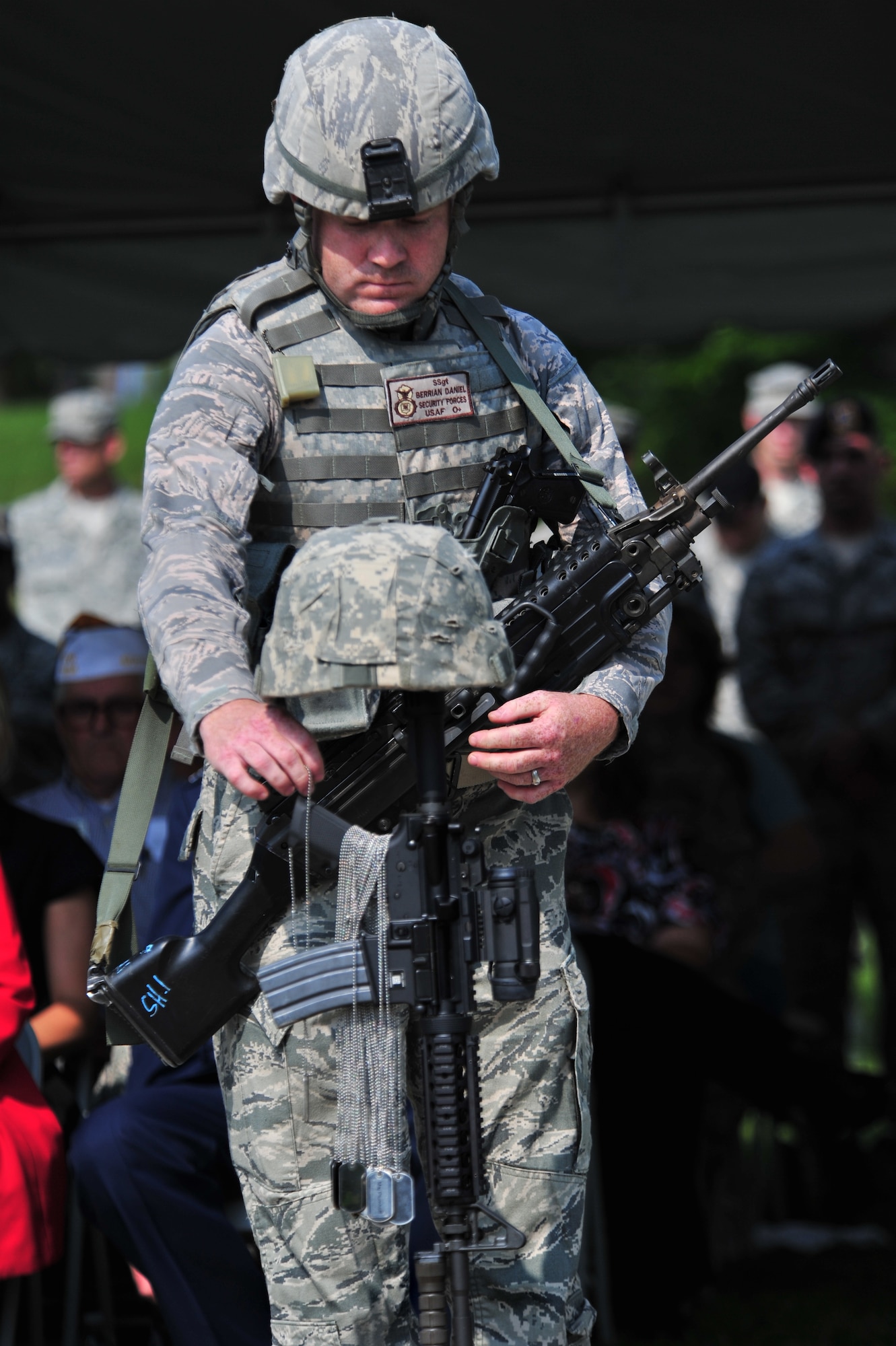 100602-F-8430J-400
SHAW AIR FORCE BASE, S.C. - Staff Sgt. Daniel Berrian, 20th Fighter Wing Security Forces, places the dog tags of one of the fallen airmen on the battle field cross at the dedication ceremony for the Fallen Airmen Memorial at Memorial Lake June 2, 2010. The Fallen Airmen Memorial is dedicated to all Airmen who have died in combat. The memorial will be a living monument, so it can be adjusted at any time as combat goes on and wars come and go. (U.S. Air Force photo/Airman 1st Class Amber E. N. Jacobs)