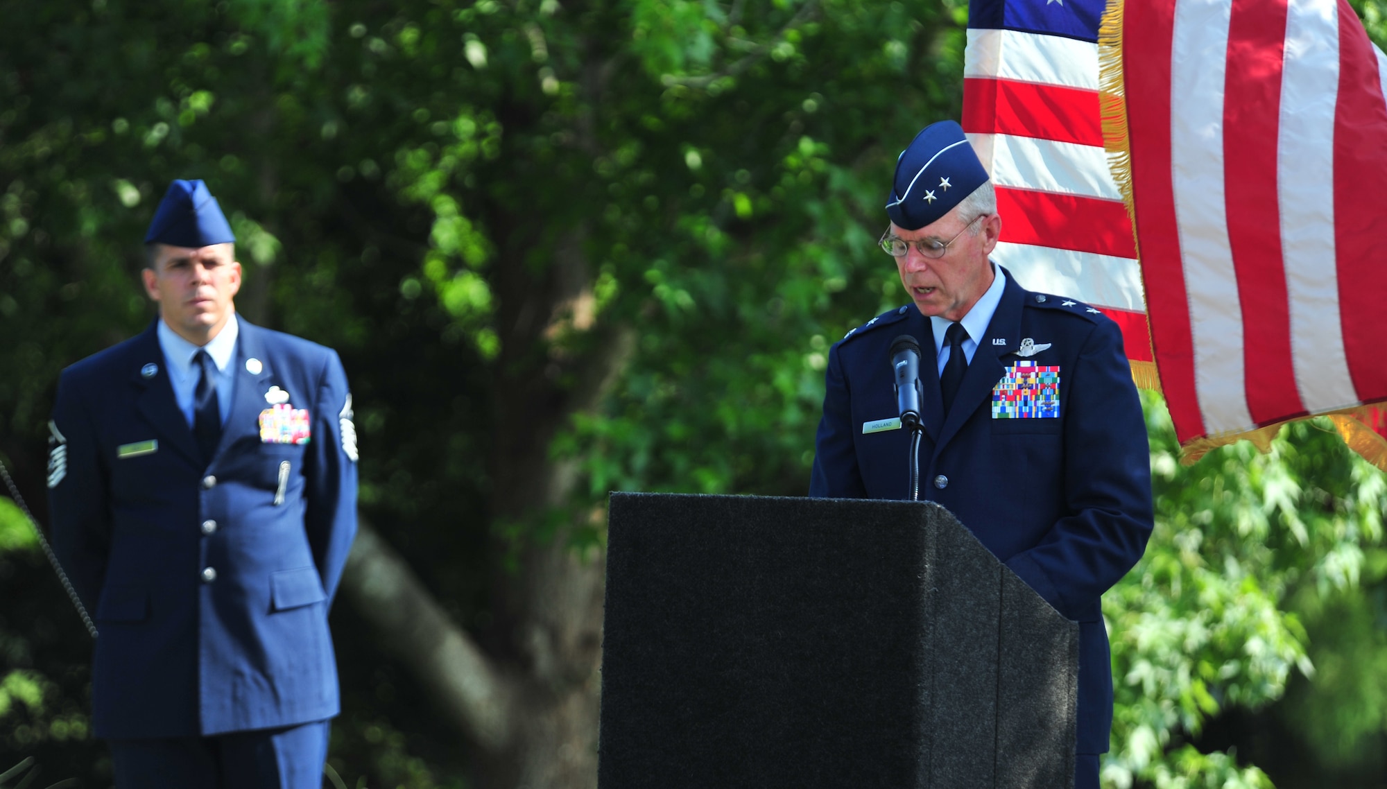 100602-F-8430J-139
SHAW AIR FORCE BASE, S.C. - Maj. Gen. Dutch Holland, 9th Air Force commander, addresses the crowd at the dedication ceremony for the Fallen Airmen Memorial at Memorial Lake while narrator Master Sgt. Dave Self, the first sergeant of the 20th Civil Engineer Squadron, overlooks the general June 2, 2010. The Fallen Airmen Memorial is dedicated to all Airmen who have died in combat. The memorial will be an on-going monument, so it can be adjusted at any time as combat goes on and wars come and go. (U.S. Air Force photo/Airman 1st Class Amber E. N. Jacobs)