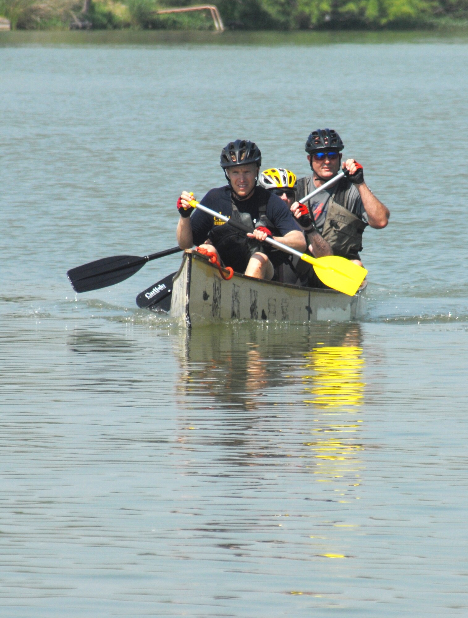 Team Tres Gringos: Army Cpl. Jordan Monroe, Army Capt. Austin Huckabee and Todd Huckabee, paddle back to the final check point during last segment of the San Angelo Loco Lizards' Adventure Race June 6. Cpl. Monroe and Capt. Austin, stationed at Fort Hood, Texas, along with Mr. Huckabee were named Fastest Team, completing the race in three hours, 22 minutes. (U.S. Air Force photo/Connie Hempel)