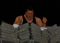 MINOT AIR FORCE BASE, N.D. -- P.J. Hoeper, Strength Team member, breaks two piles of cement blocks at the base theater here June 2. After crushing the bricks, Hoeper gave an inspirational speech about his relationship with God to those in attendance. (U.S. Air Force photo by Senior Airman Ashley N. Avecilla)