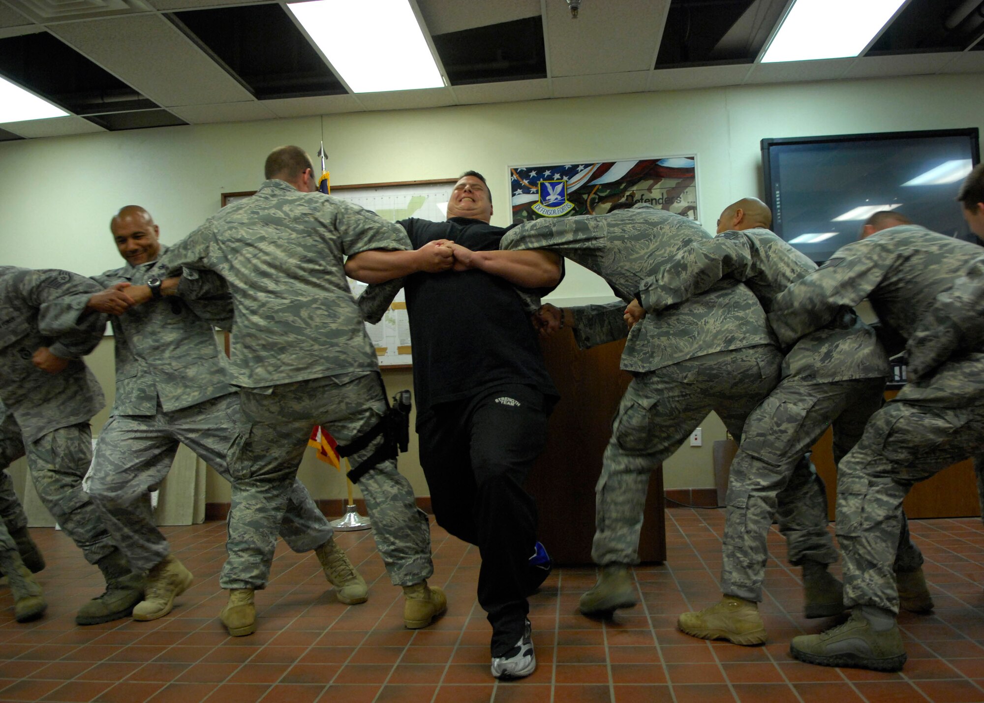 MINOT AIR FORCE BASE, N.D. -- P.J. Hoeper, Strength Team team member, participates in a human tug-o-war with members from the 91st Security Forces Squadron here June 2. The visit from the Strength team was way to remind Airmen why they joined the military and how choices affected their lives. (U.S. Air Force photo by Senior Airman Ashley N. Avecilla)