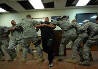MINOT AIR FORCE BASE, N.D. -- P.J. Hoeper, Strength Team team member, participates in a human tug-o-war with members from the 91st Security Forces Squadron here June 2. The visit from the Strength team was way to remind Airmen why they joined the military and how choices affected their lives. (U.S. Air Force photo by Senior Airman Ashley N. Avecilla)