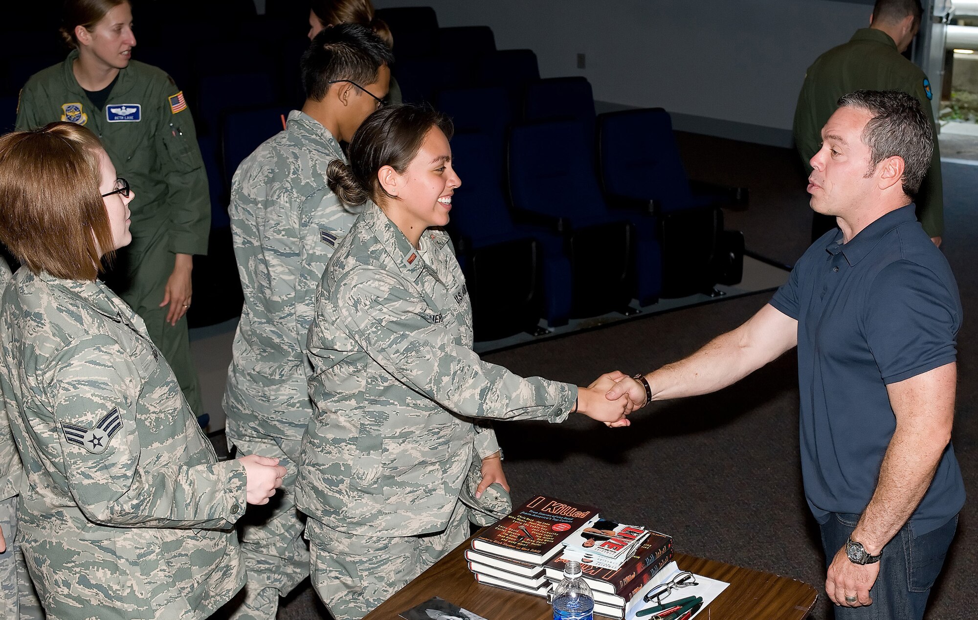 (Right) Comedian Bernie McGrenanhan shakes hands with 2nd Lt. Jennifer Guerrero, 436th Airlift Wing Public Affairs Chief of Media Relations, after a presentation of 'Comedy is the Cure,' June 3 and 4 at the Dover Air Force Base Theater. Mr. McGrenahan shares his life story of being a former 'A' student and athlete, as well as a high-risk drinker who had lost it all. He also delivers a 30-minute serious talk on alcohol, drug and sexual assault prevention, and risk-reduction safety.