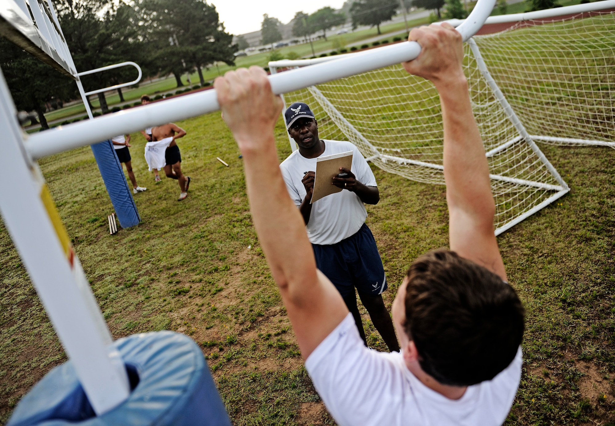 Staff Sgt. Holmes, recruiter in Greensville, Miss., tracks the number of pull ups a battlefield Airman trainee does  June 4, 2010 at Little Rock Air Force Base, AR. Future Airmen, currently in the delayed entry program, were given the opportunity to train with Air Force combat controllers, pararescuemen and various other special operations career fields. The training is designed to better prepare them for the indoctrination course that they will go through for their specific career field. (U.S. Air Force photo/ Senior Airman Ryan Crane)