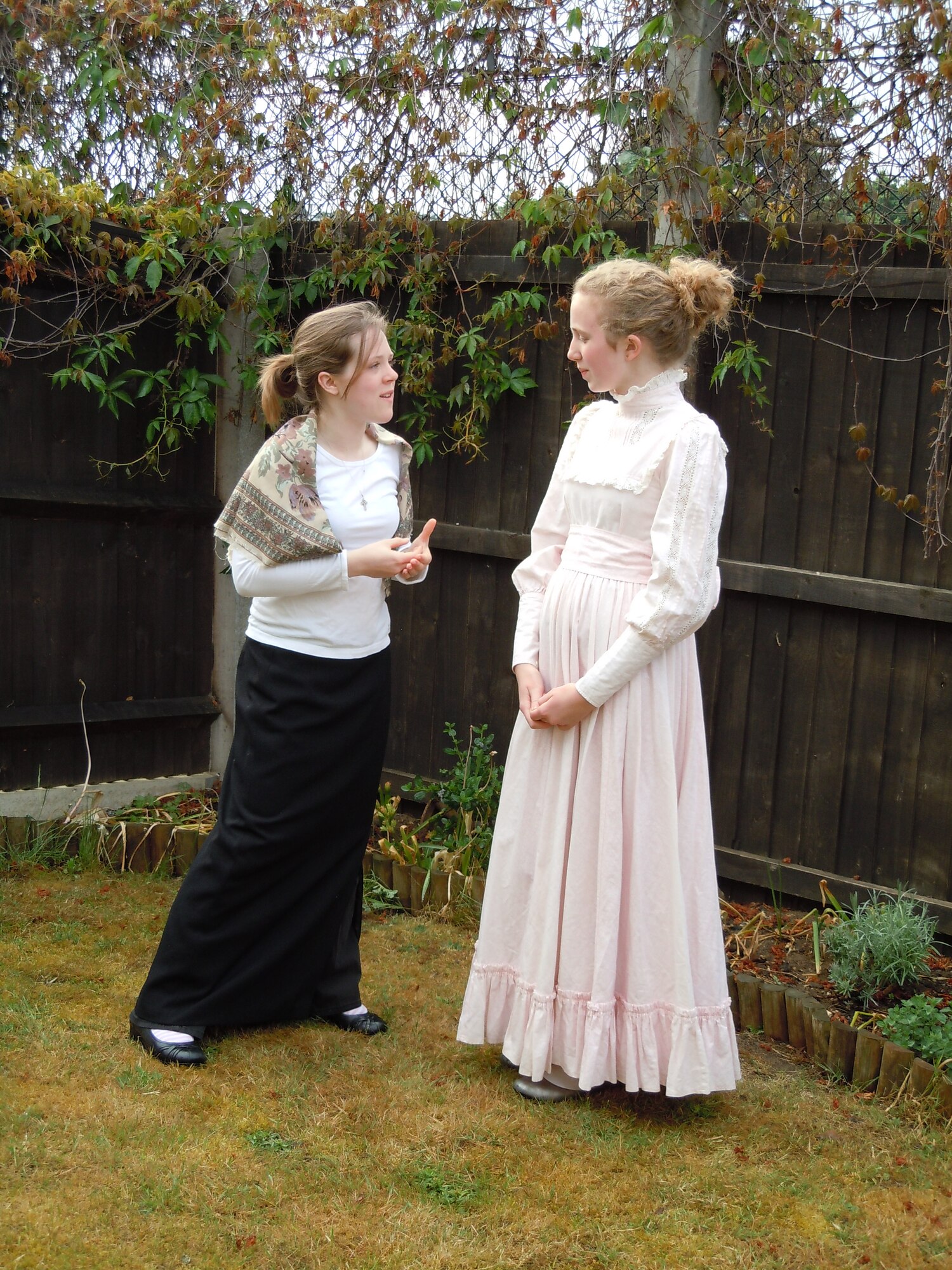 Abigail Moermond, 13-year-old daughter of Chaplain (Maj.) Timothy Moermond, 48th Fighter Wing Chapel, assumes the role of a mother who’s against women receiving the right to vote and questions the motives of “women's suffrage leader Carrie Chapman Catt,” played by Jordyn Kent, 12-year-old daughter of Lt. Col. Debbie Kent, 48th Logistics Readiness Squadron commander, during a practice session May 22 at the base chapel.  The two Lakenheath Middle School students will perform a 10-minute skit about women’s suffrage and represent the Department of Defense Dependents School Europe at the National History Day contest at the University of Maryland June 13-17. (Courtesy photo by U.S. Air Force Chaplain (Maj.) Timothy Moermond)