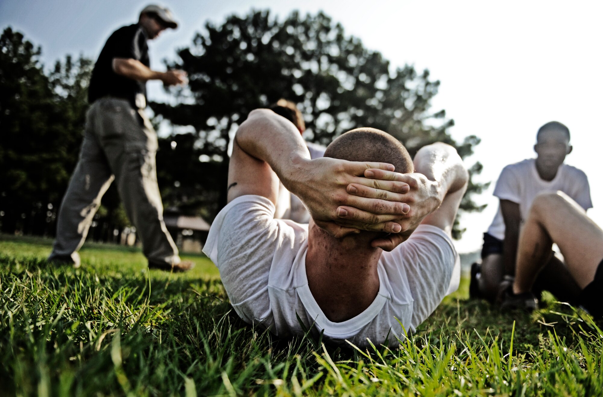 A Battlefield Airman trainee performs the sit-up portion of his physical ability and stamina test  as the instructor looks on June 2, 2010 at Little Rock Air Force Base, AR. Future Airmen, currently in the delayed entry program, were given the opportunity to train with Air Force combat controllers, pararescuemen and various other special operations career fields. The training is designed to better prepare them for the indoctrination course that they will go through for their specific career field. (U.S. Air Force photo/ Senior Airman Ryan Crane)