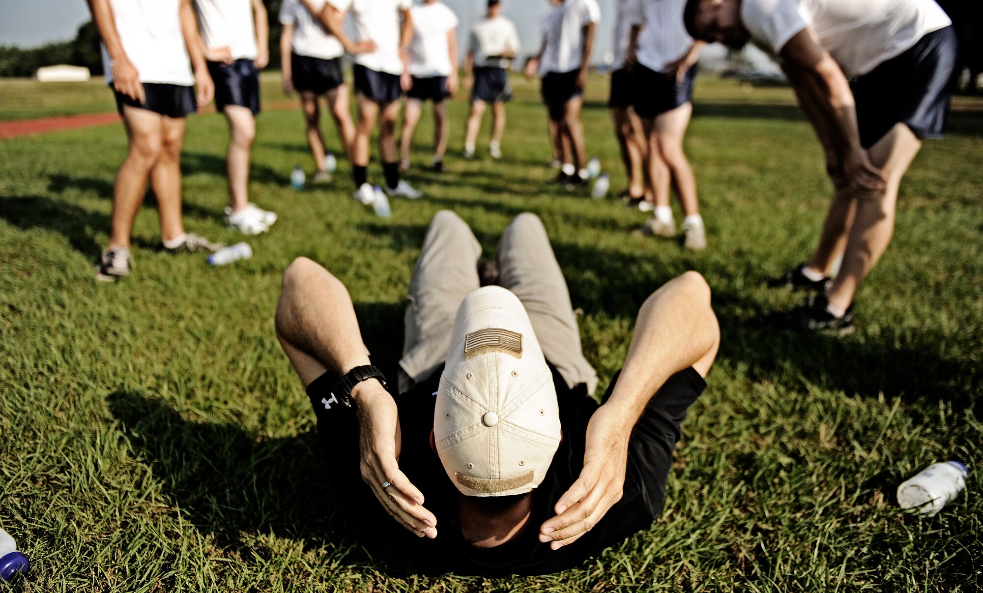 Battlefield Airman trainees gather around as an instructor demonstrates the proper way to perform the sit-up portion of the physical ability and stamina test June 2, 2010 at Little Rock Air Force Base, AR. Future Airmen, currently in the delayed entry program, were given the opportunity to train with Air Force combat controllers, pararescuemen and various other special operations career fields. The training is designed to better prepare them for the indoctrination course that they will go through for their specific career field. (U.S. Air Force photo/ Senior Airman Ryan Crane)