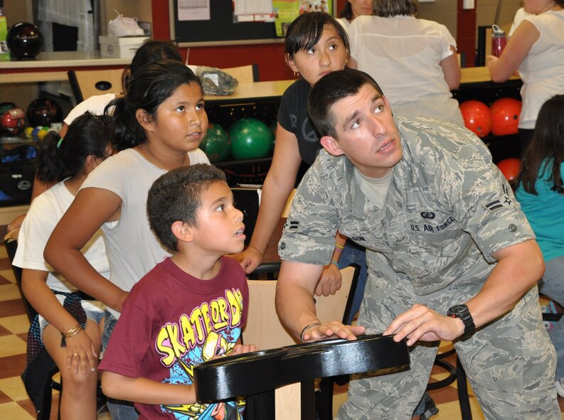 LAUGHLIN AIR FORCE BASE, Texas – Airman 1st Class Anthony Nelson, 47th Comptroller Squadron, helps children from one of Del Rio’s elementary schools get ready to bowl at Cactus Lanes here June 3 during an event sponsored by the Laughlin Education and Enrichment Program. Airman Nelson is one of more than 50 Laughlin members who volunteer their time to LEEP, which is geared toward mentoring young children. (U.S. Air Force photo by Airman 1st Class Blake Mize)