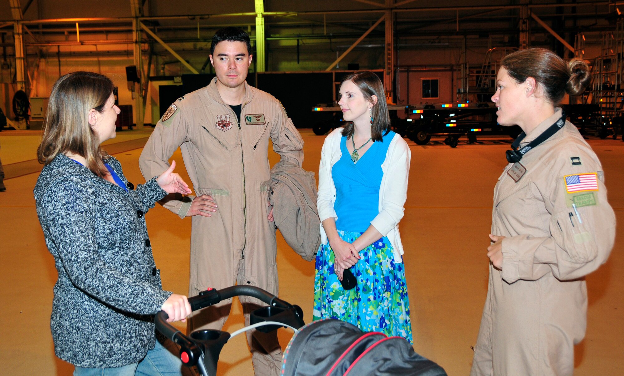 Friends and family of Capt. Chris Cunningham, 56th Rescue Squadron flight commander, and Capt. Marisa Catlin, 48th Fighter Wing flight safety officer, welcome them home from their recent 90-day deployment at Hangar 7 at RAF Lakenheath, England, June 7. The 56 RQS completed more than 540 sorties during their deployment at Bagram Air Base, Afghanistan. (From left to right) Sandy Rodgers, wife of Capt. Jason Rodgers, 56 RQS director of staff, Capt. Chris Cunningham, and wife Ashley, Capt. Marisa Catlin. (U.S. Air Force photo/Airman 1st Class Eboni Knox)