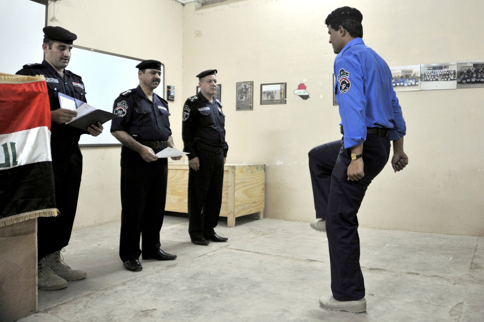 An Iraqi police academy graduate from the Taji Law Enforcement Academy marches up to receive his certificate June 3, 2010, at Camp Taji, Iraq. The academy students were instructed on subjects such as evidence gathering, crime scene sketching, finger printing and securing a building. (U.S. Air Force photo/Senior Airman Perry Aston) 