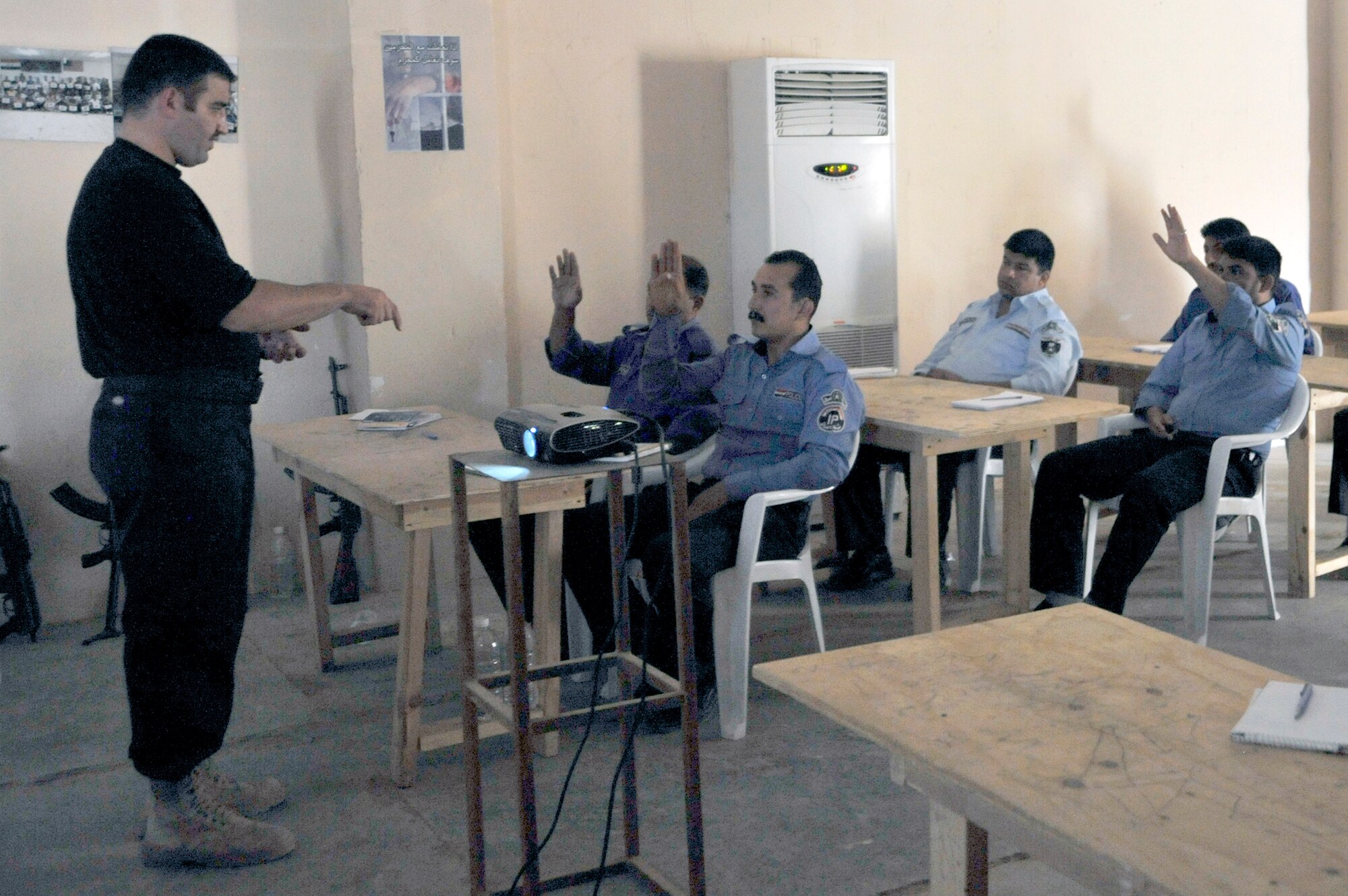 Lt. Ahed teaches Iraqi police academy students about the importance of gathering evidence in a crime scene, June 2, 2010, at Camp Taji, Iraq. This was the final day of class before graduation. The 732nd Expeditionary Security Forces Squadron, Det. 3 Airmen completed their mission of facilitating the academy for the past 10 months. Lieutenant Ahed is an Iraq Ministry of Interior instructor. (U.S. Air Force photo/Senior Airman Perry Aston)