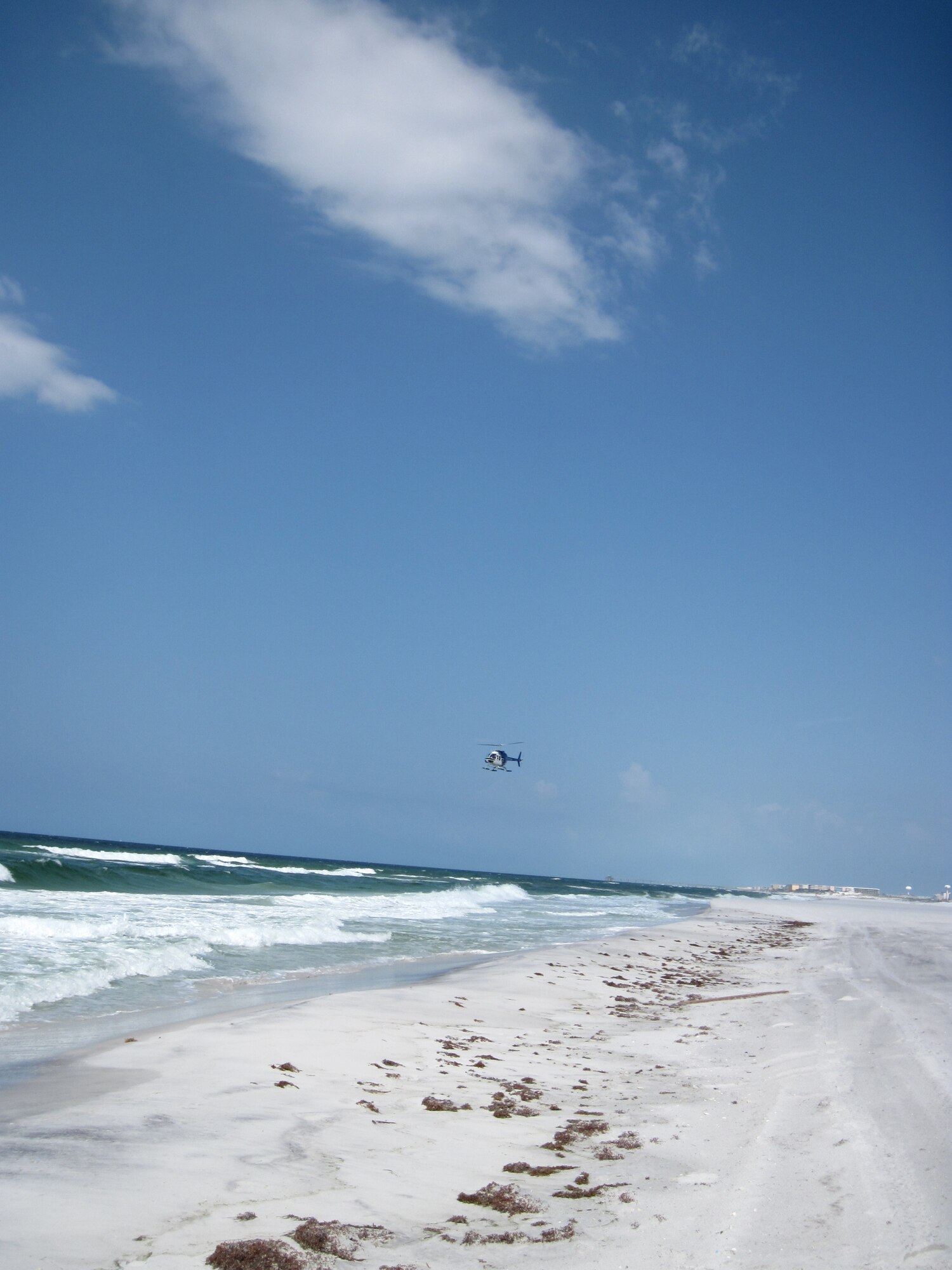 EGLIN AIR FORCE BASE, Fla. -- The aerial surveillance helicopter flies over Eglin beaches Sunday looking for oil and distressed wildlife from the Deepwater Horizon oil leak. BP Shoreline Cleanup Assessment Teams are currently on-site at several locations on Eglin property cleaning the oil as it's discovered. (USAF photo/Mike Spaits)

                              